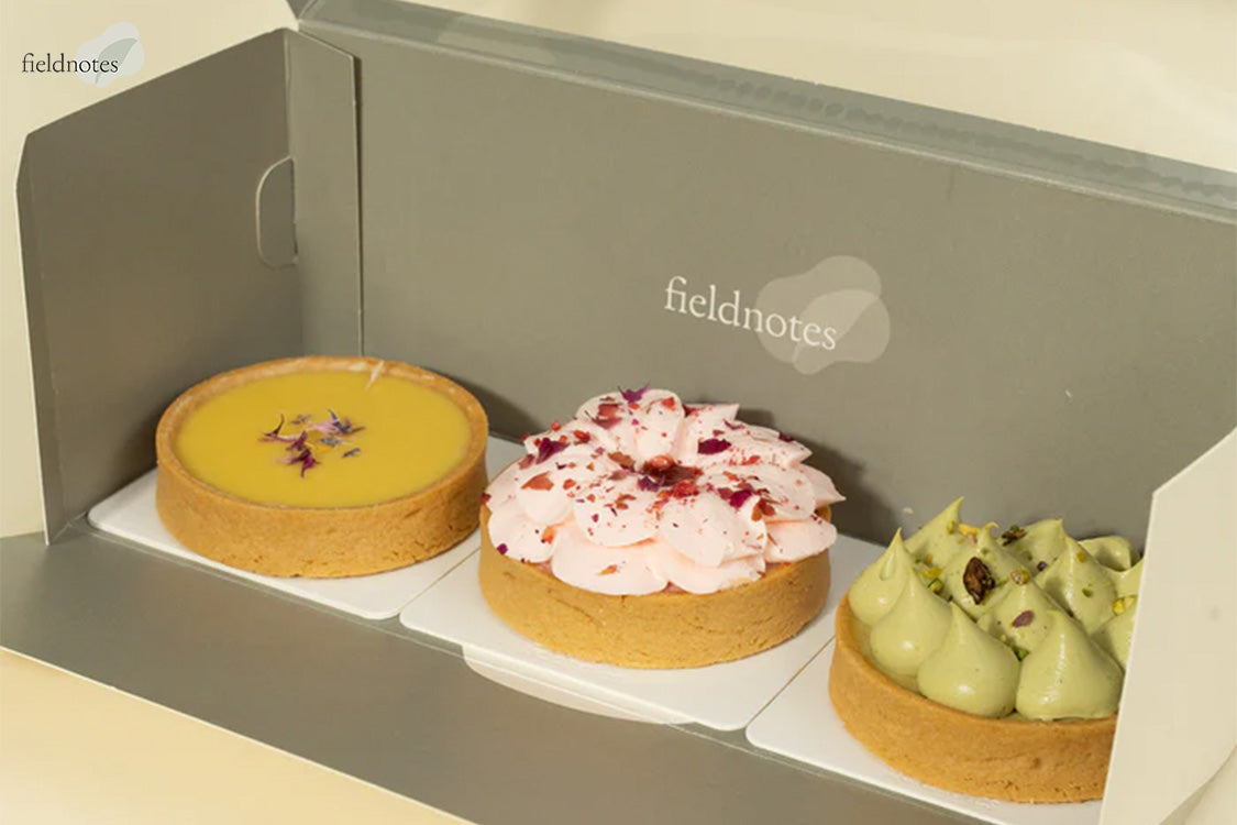 Fieldnotes dessert box with signature lemon, rose, and pistachio tarts.