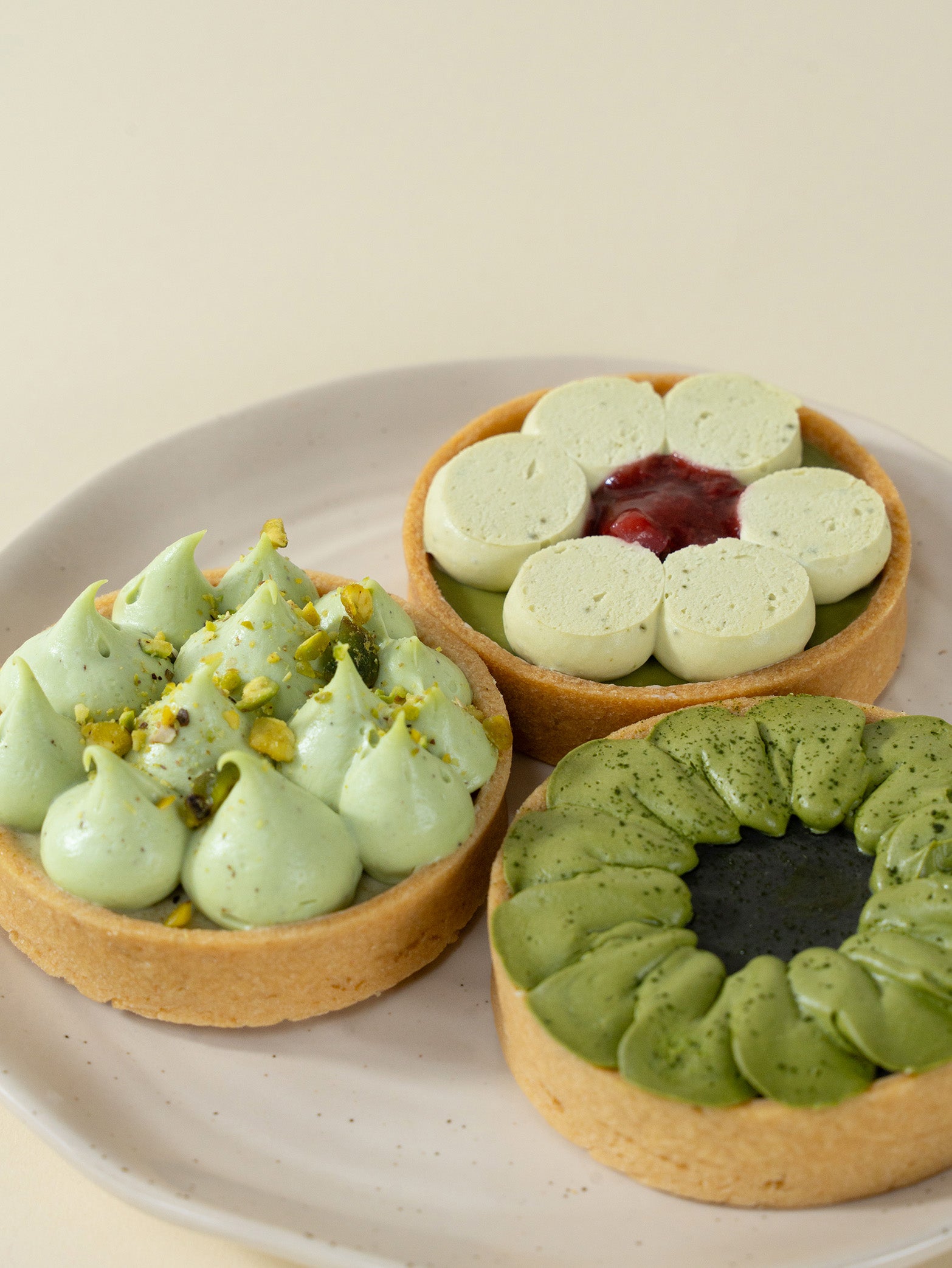 A box of assorted tarts with pistachio, strawberry, and matcha flavors, for tarts order online in Singapore