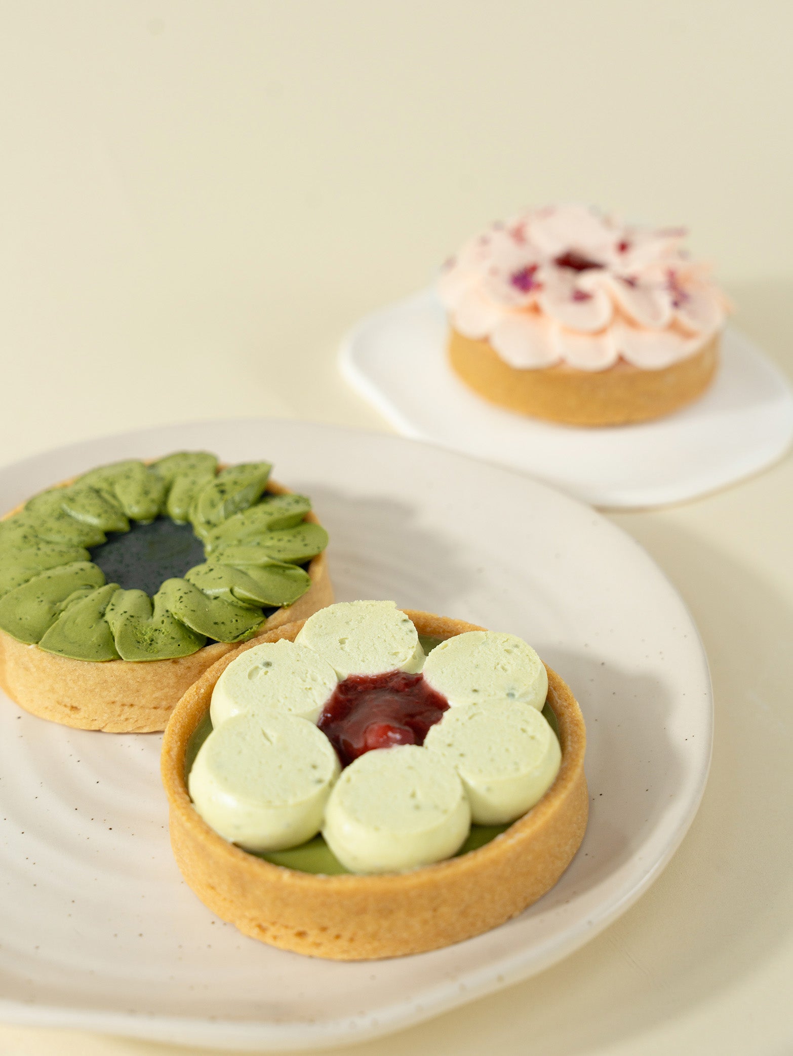 A box of three assorted tarts with a variety of fillings and toppings, including matcha green tea, strawberry, and rose flavors for online order for delivery in Singapore
