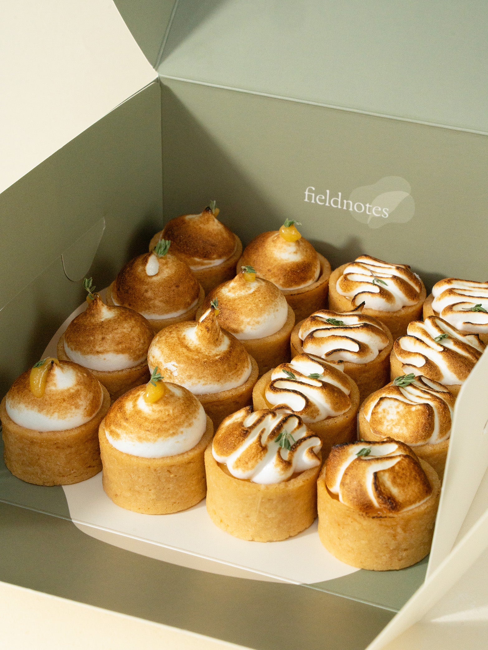 A box of assorted mini meringue tarts with lemon and yuzu flavors, order online for Singapore delivery