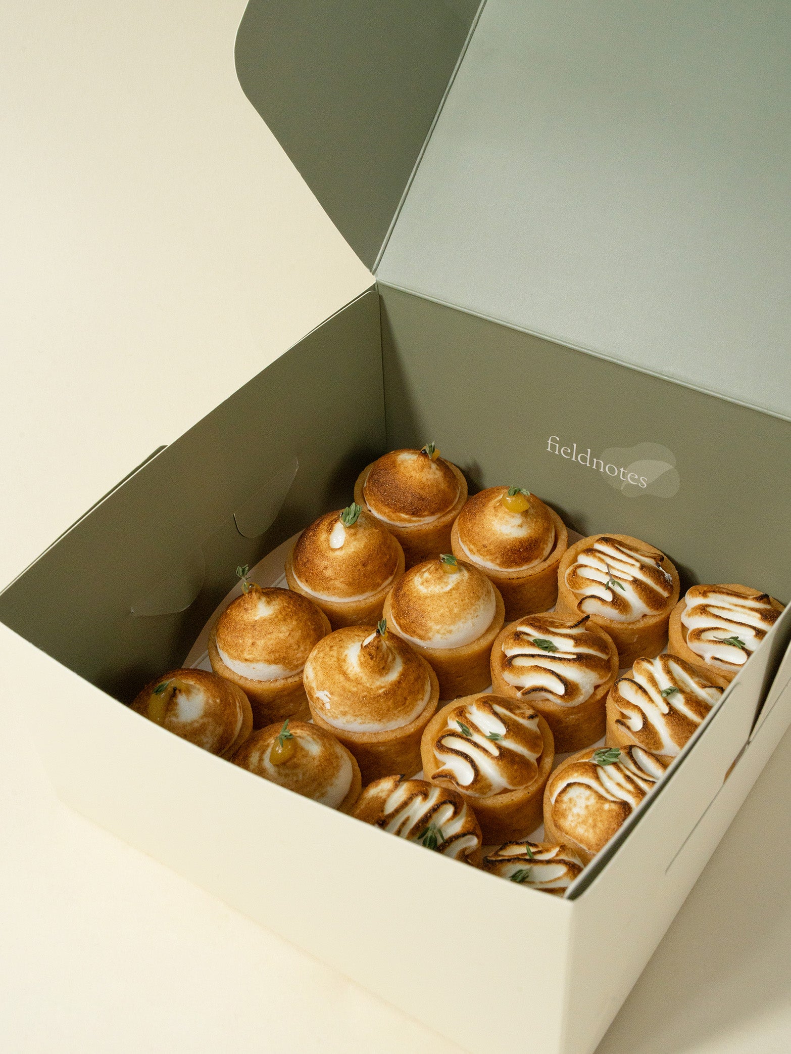 A box of assorted mini meringue tarts with lemon and yuzu flavors, order online for Singapore delivery