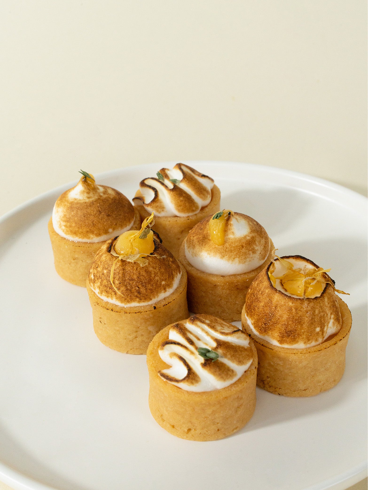 A box of assorted mini meringue tarts with lemon and yuzu flavors, order online for Singapore delivery