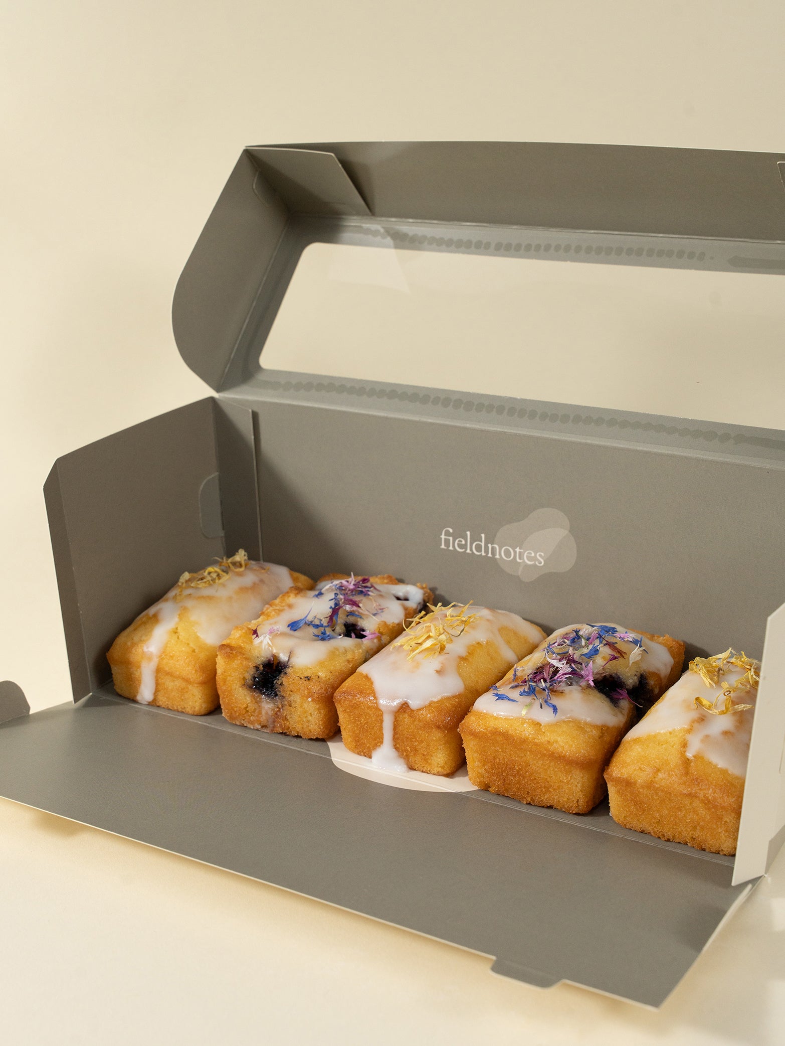 A box of assorted loaf desserts, including lemon and blueberry, neatly packaged for gifting. Available for delivery islandwide Singapore