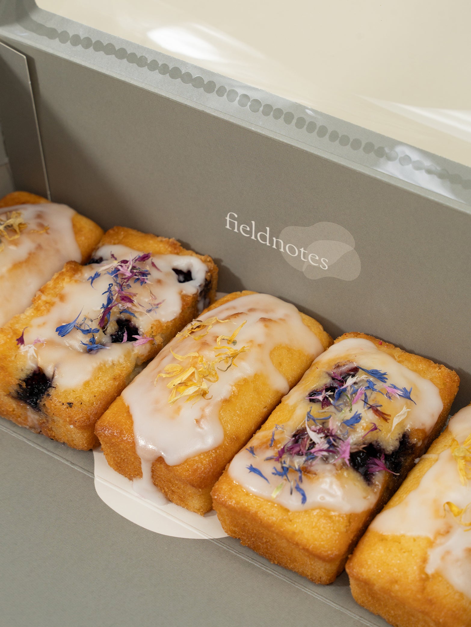 A box of assorted loaf desserts, including lemon and blueberry, neatly packaged for gifting. Available for delivery islandwide Singapore