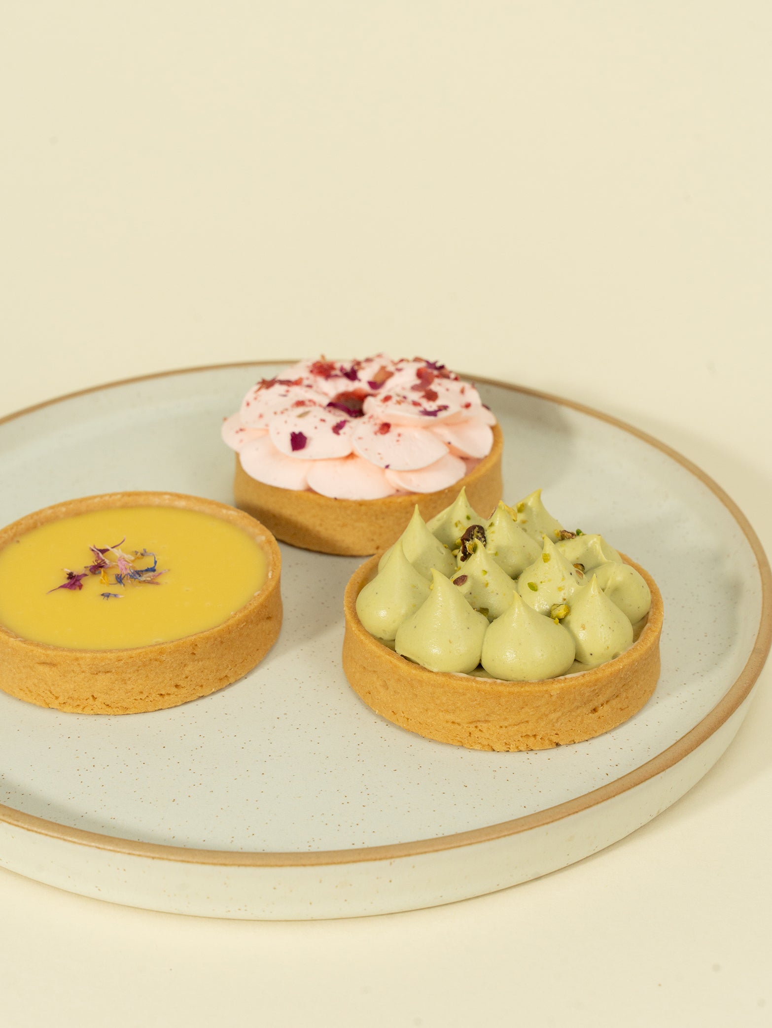 A box of three tarts - strawberry rose, white chocolate passionfruit, and pistachio tart for online order in Singapore