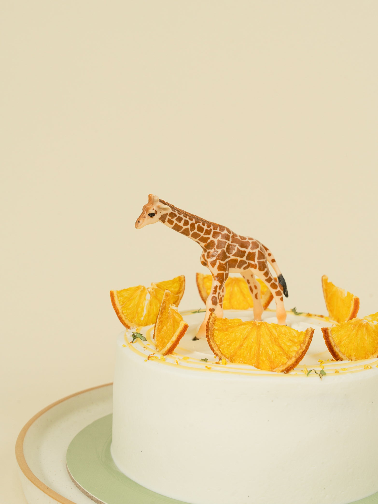 Citrus fruit cake with minimalistic toy giraffe