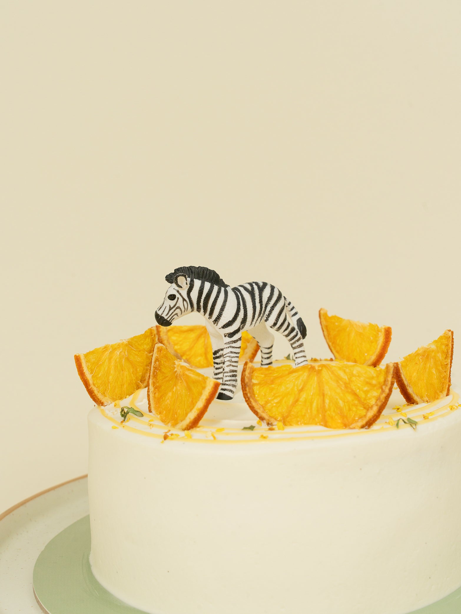 Citrus fruit cake with minimalistic toy zebra