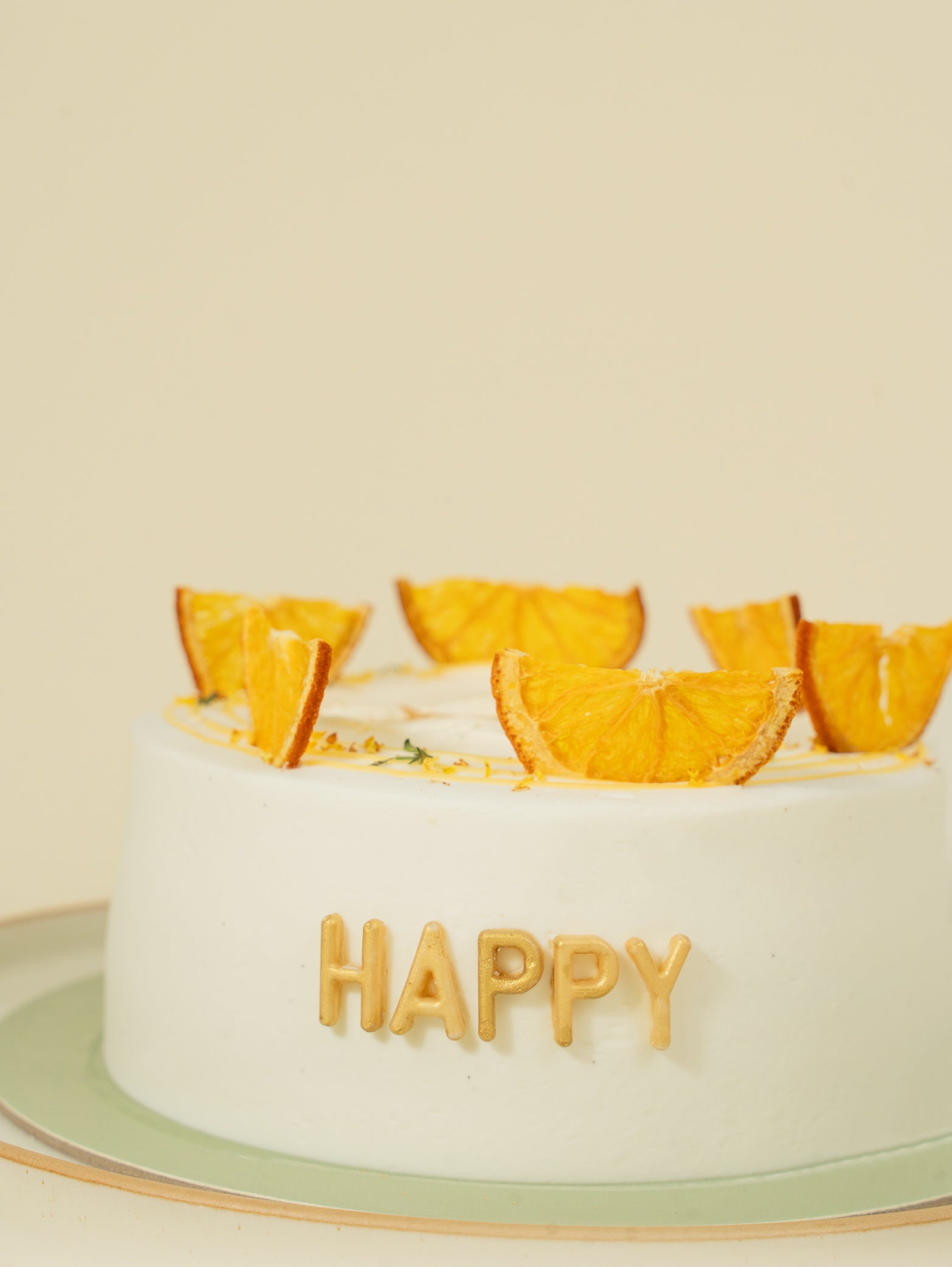 Happy cake with buttercream frosting and fruit decorations.