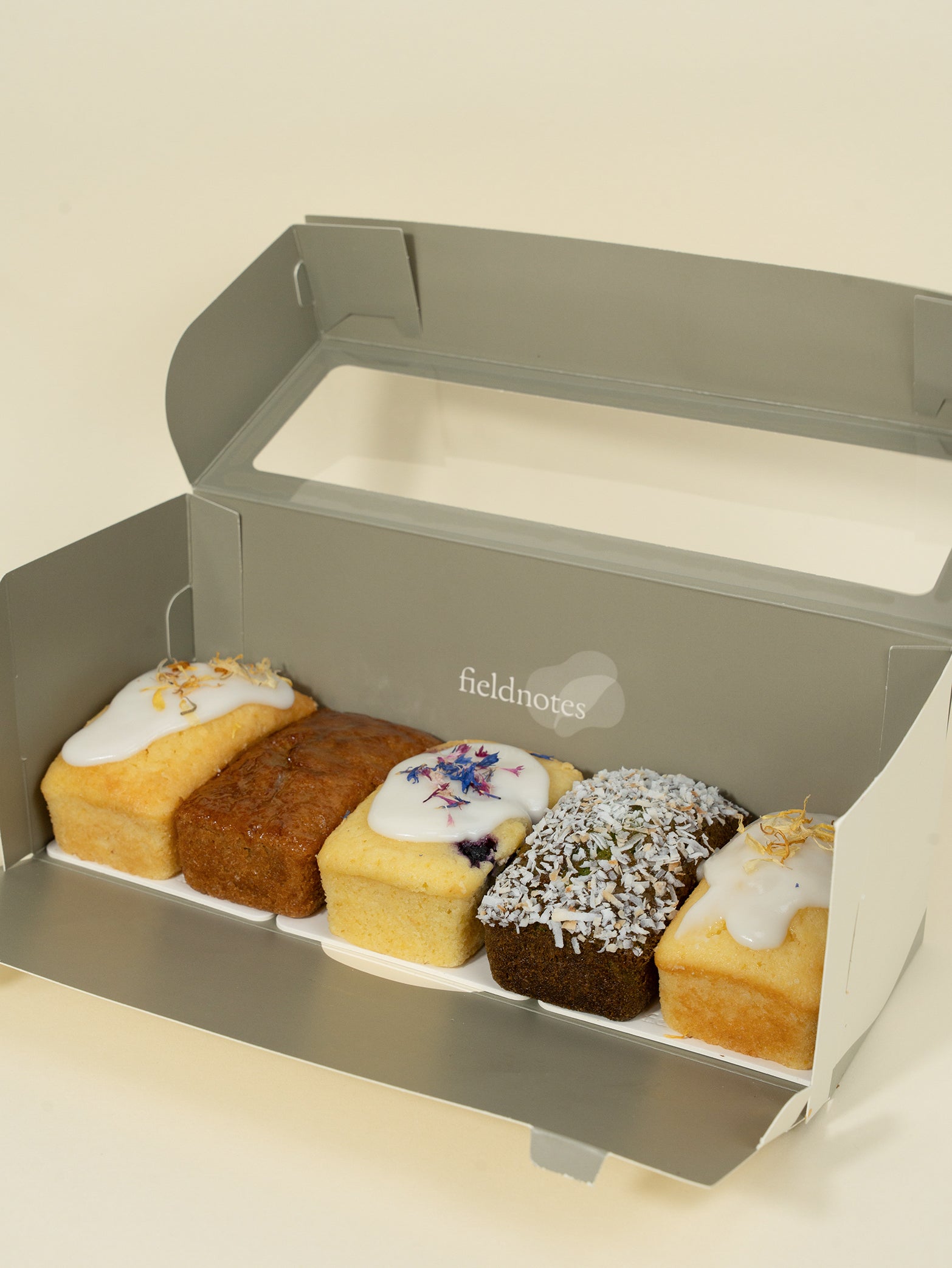 A box of assorted loaf desserts, including lemon and blueberry, neatly packaged for gifting. Available for delivery islandwide Singapore