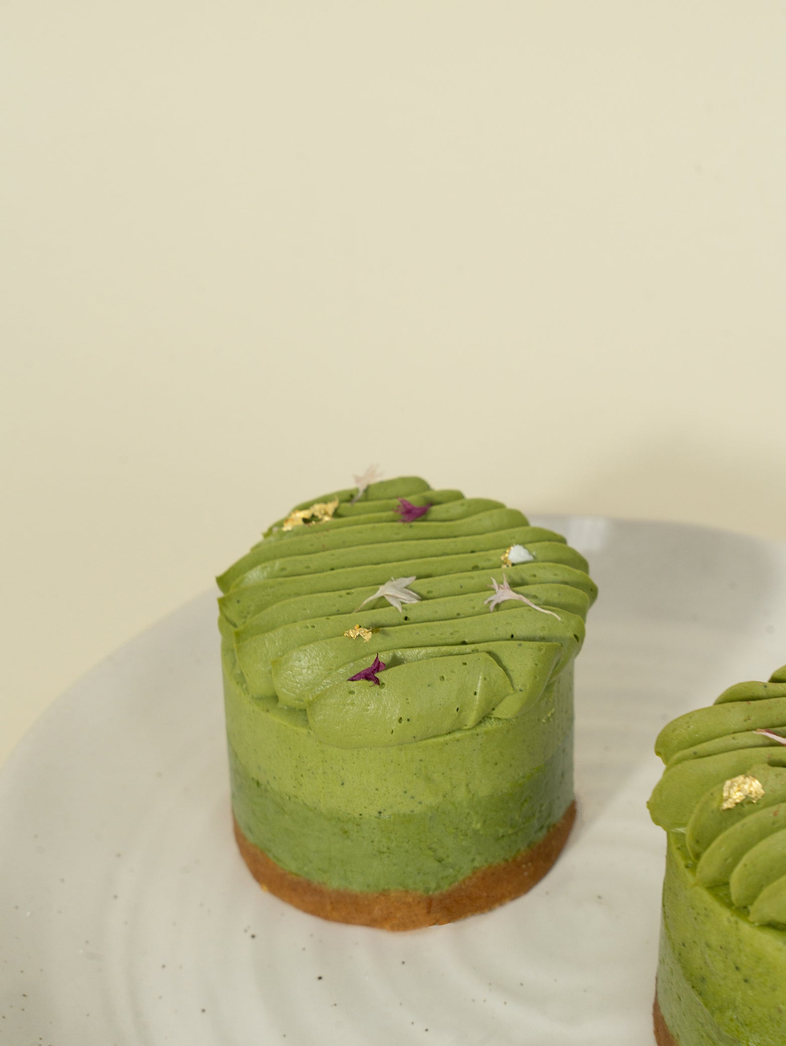 Uji creamy matcha cheesecake adorned with gold leaf, available for online order for delivery in Singapore