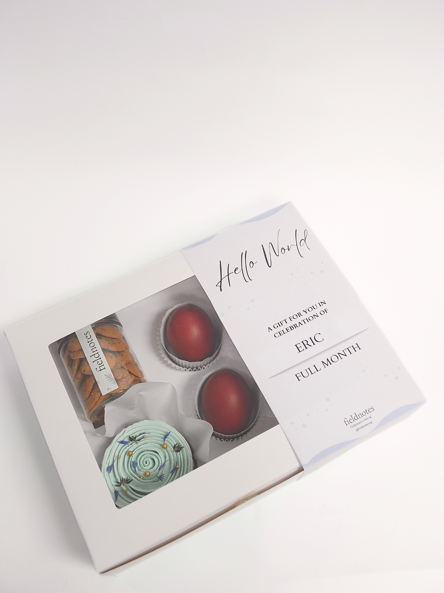 A full month gift box containing an assortment of sweet treats, including cupcakes, cookies, available for online delivery in Singapore