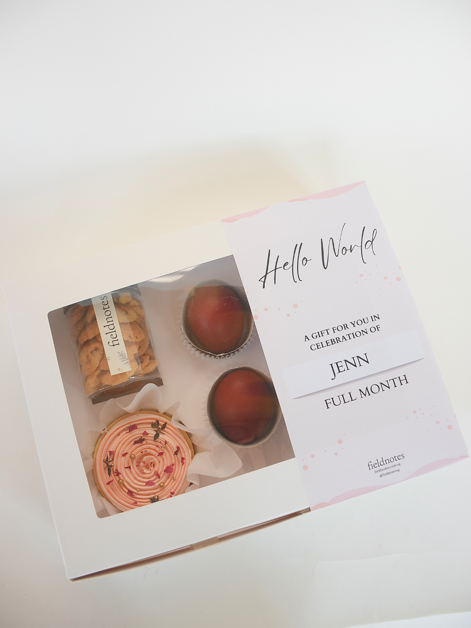 A full month gift box containing an assortment of sweet treats, including cupcakes, cookies, available for online delivery in Singapore