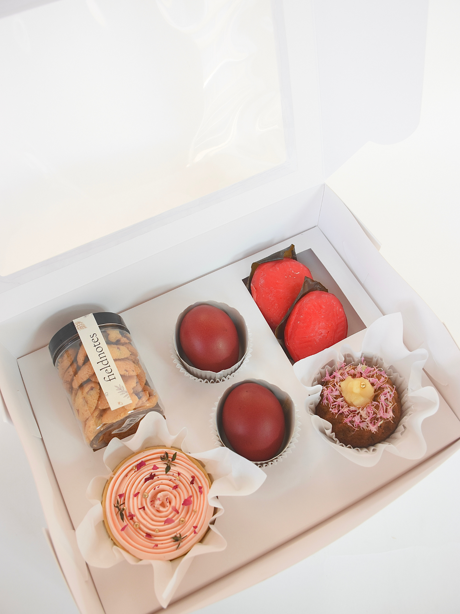 A full month gift box containing an assortment of sweet treats, including cupcakes, cookies, available for online delivery in Singapore
