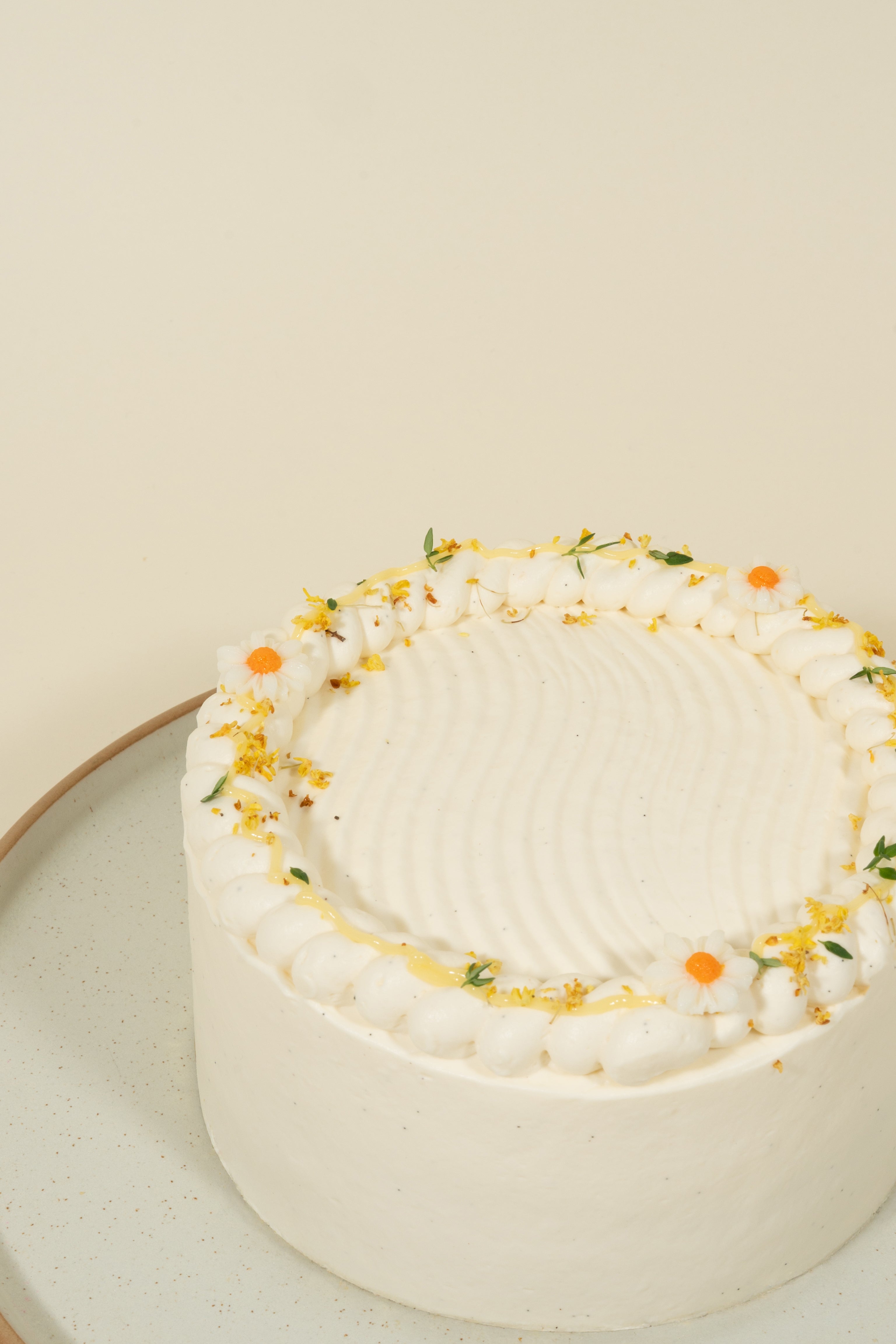 The Honey Yuzu birthday cake by fieldnotes features yuzu sponge, Manuka Honey cream, and yellow-orange flowers atop a tart-like base.