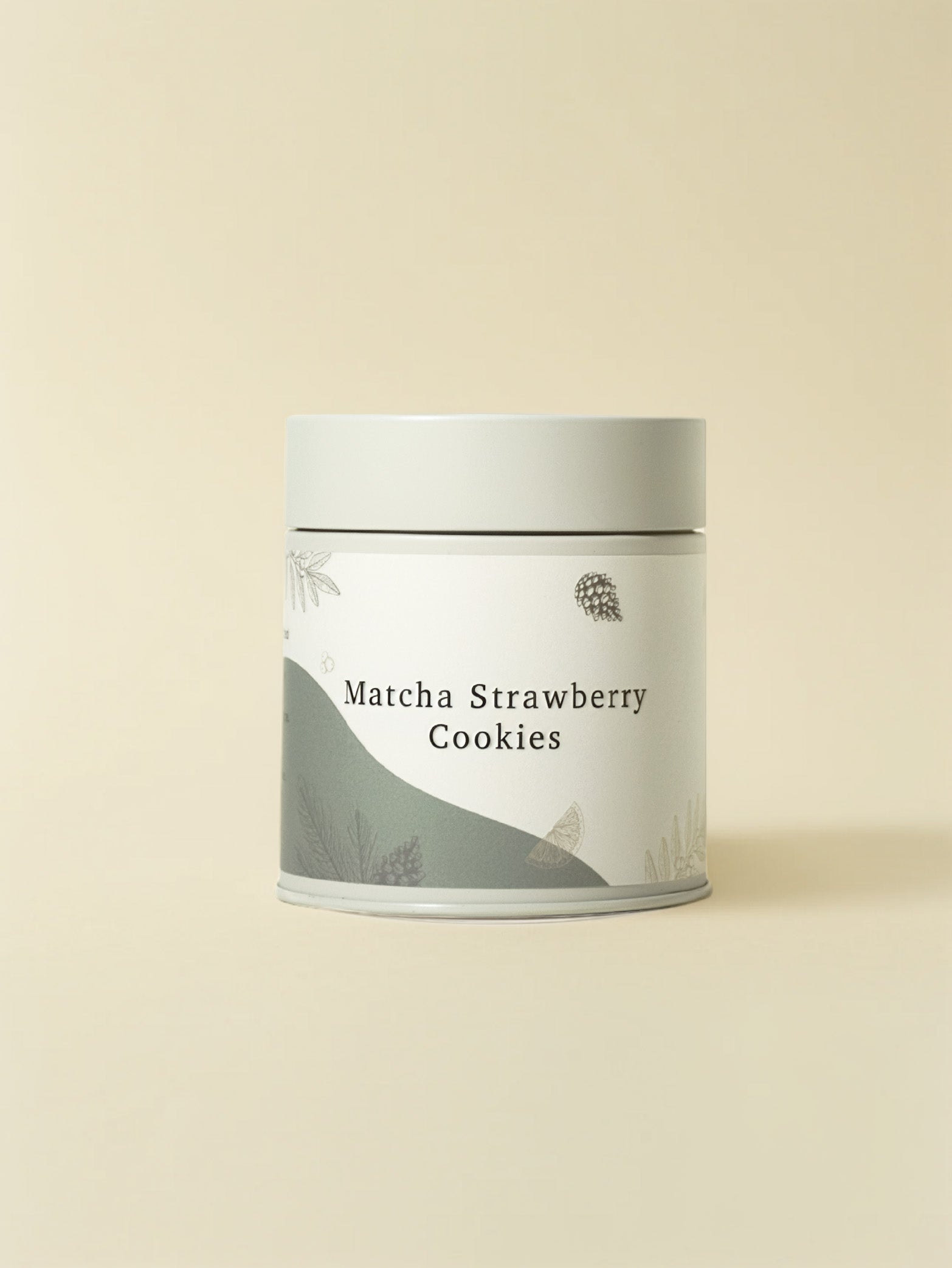 A cylindrical tin from fieldnotes labeled “Matcha Strawberry Cookies (Tin) | Next Day Delivery” features a minimalist pale beige design with subtle botanical illustrations, evoking the sweetness of birthday cake or tart and highlighting the handcrafted cookies inside.