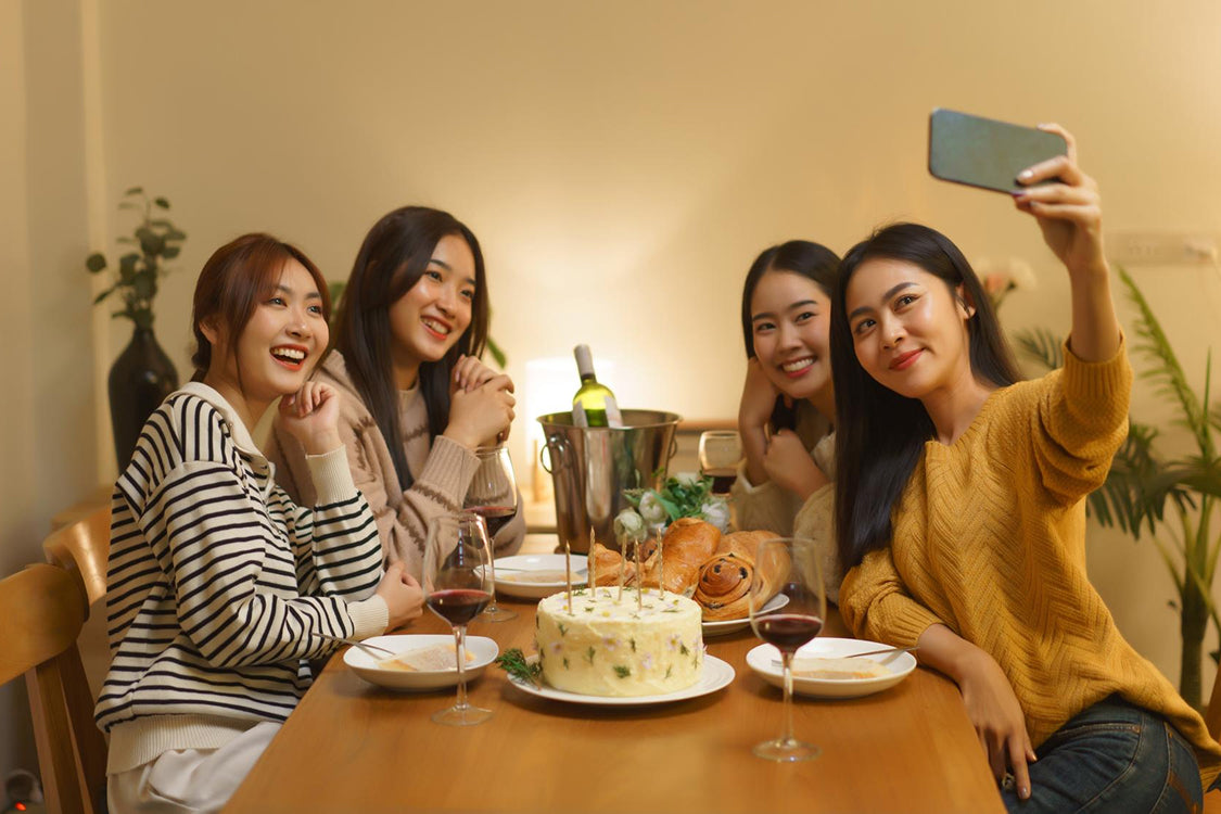 Friends sharing a celebratory cake at a dinner.