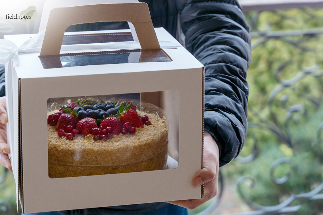 Delivery person handing over cake box