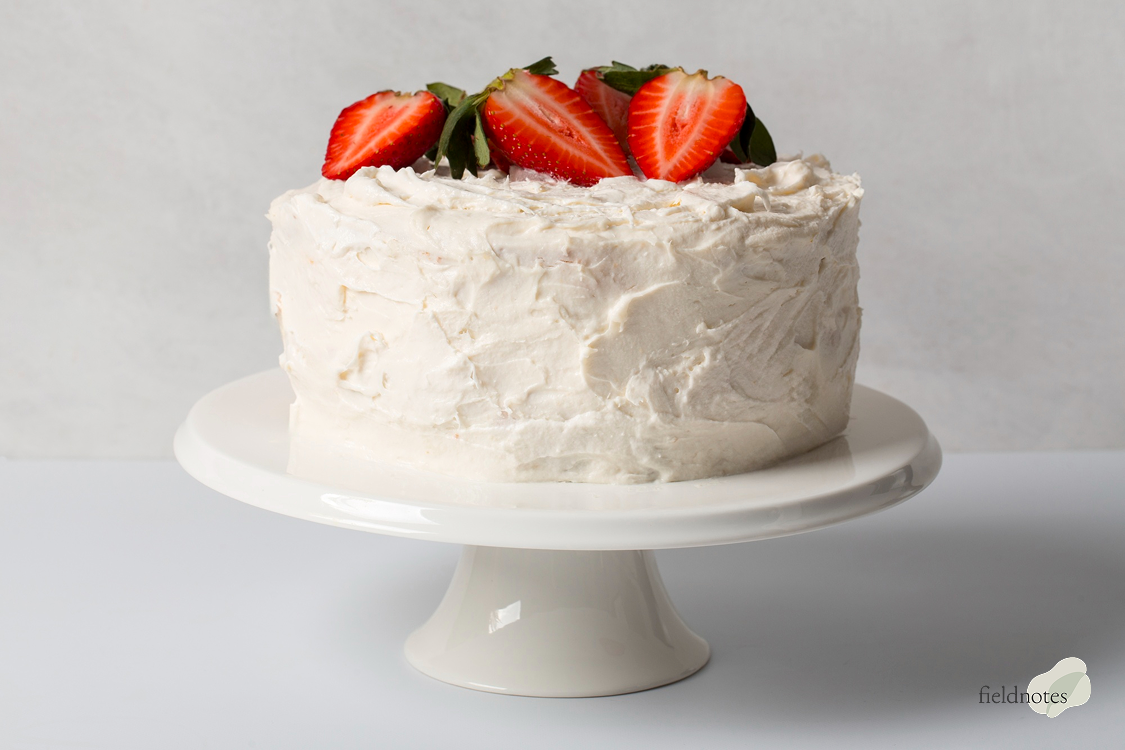 Fresh strawberry cake on a pedestal stand