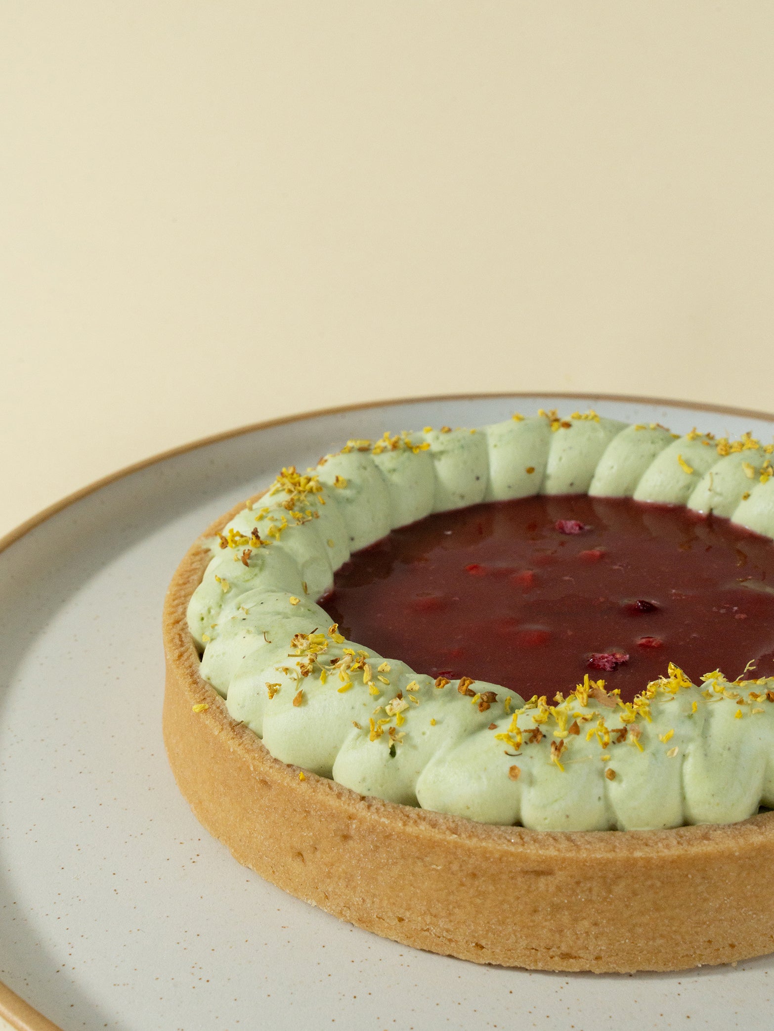 A Raspberry Pistachio Tart on a plate
