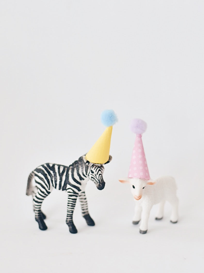 Toy animal with party hat cake topper